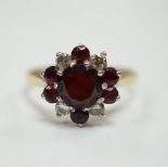 An 18ct red paste? and diamond cluster set flower head ring, size M, gross weight 3.2 grams.