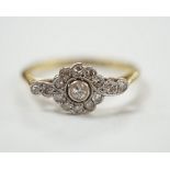 A Belle Epoque 18ct, plat and diamond cluster set target ring, with diamond set shoulders, size P,