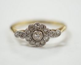 A Belle Epoque 18ct, plat and diamond cluster set target ring, with diamond set shoulders, size P,
