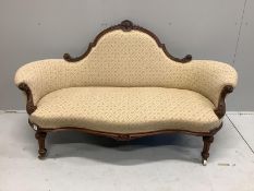 A late Victorian carved walnut settee, width 170cm, depth 74cm, height 92cm