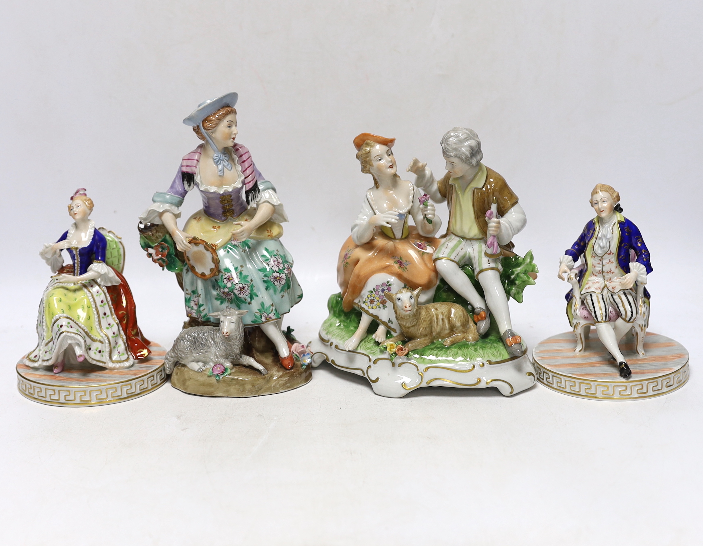 A pair of Dresden figures, a Sitzendorf shepherdess group and another German group