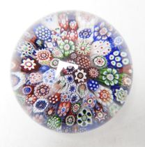 A Baccarat close packed millefiori paperweight with two rose corner, 7cm diameter