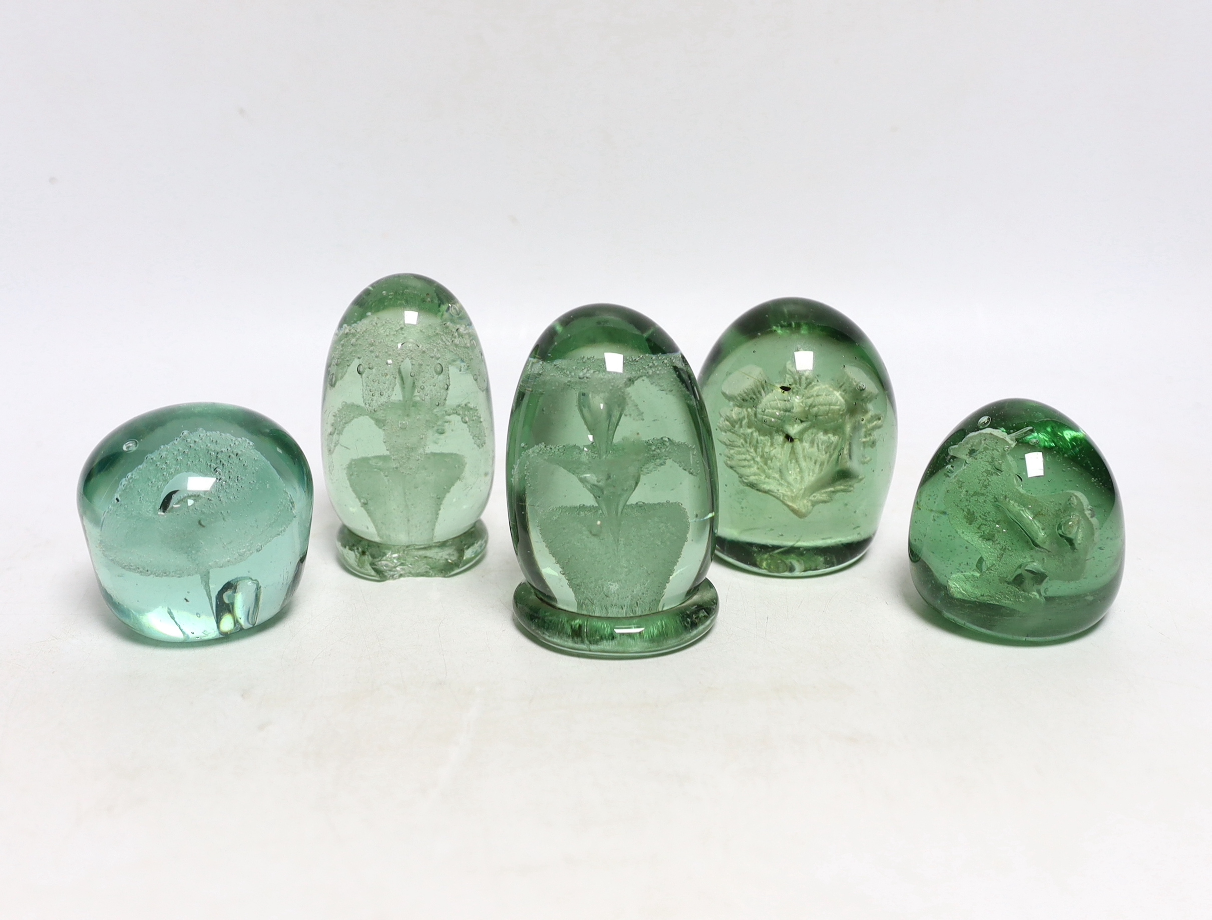 Five green glass dumps, including two with inset sulphides, tallest 9cm