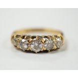 A late Victorian 18ct gold and graduated five stone diamond set half hoop ring, size L/M, gross