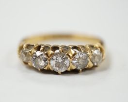 A late Victorian 18ct gold and graduated five stone diamond set half hoop ring, size L/M, gross