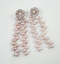 A modern pair of white metal, diamond chip cluster and three row pink cultured pearl tassel drop