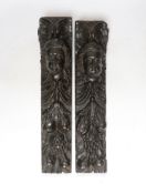 A pair of 17th century carved oak jambs, carved with putti decoration, 39cm