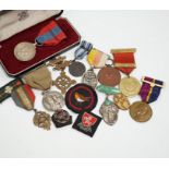 A collection of medals and badges, including eight Special Constabulary Service Medals, Fire Service