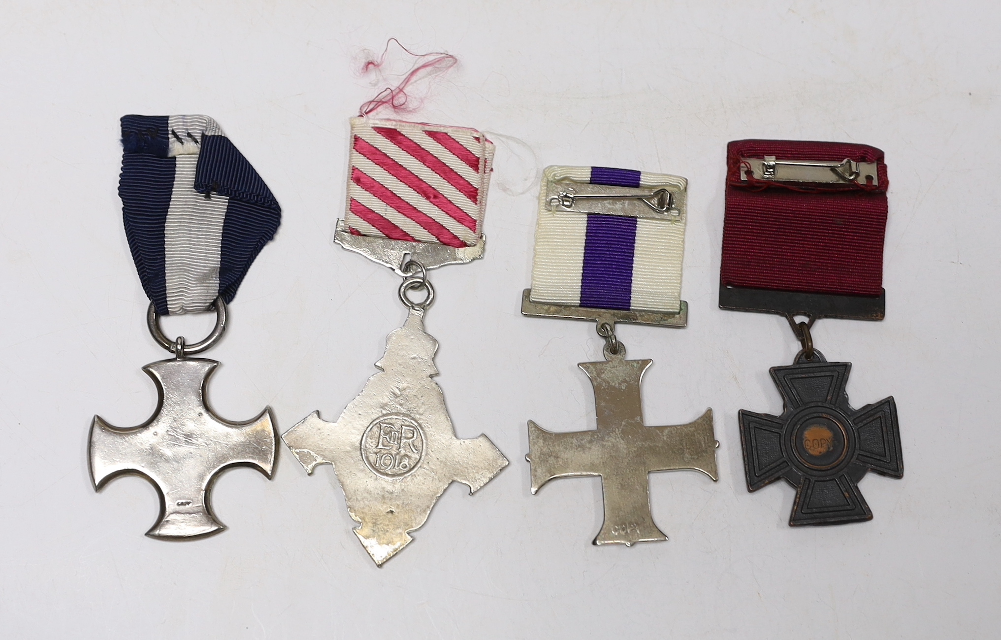 Four well produced replica medals. A Victoria Cross, a Distinguished Service Cross, a Military Cross - Image 2 of 2