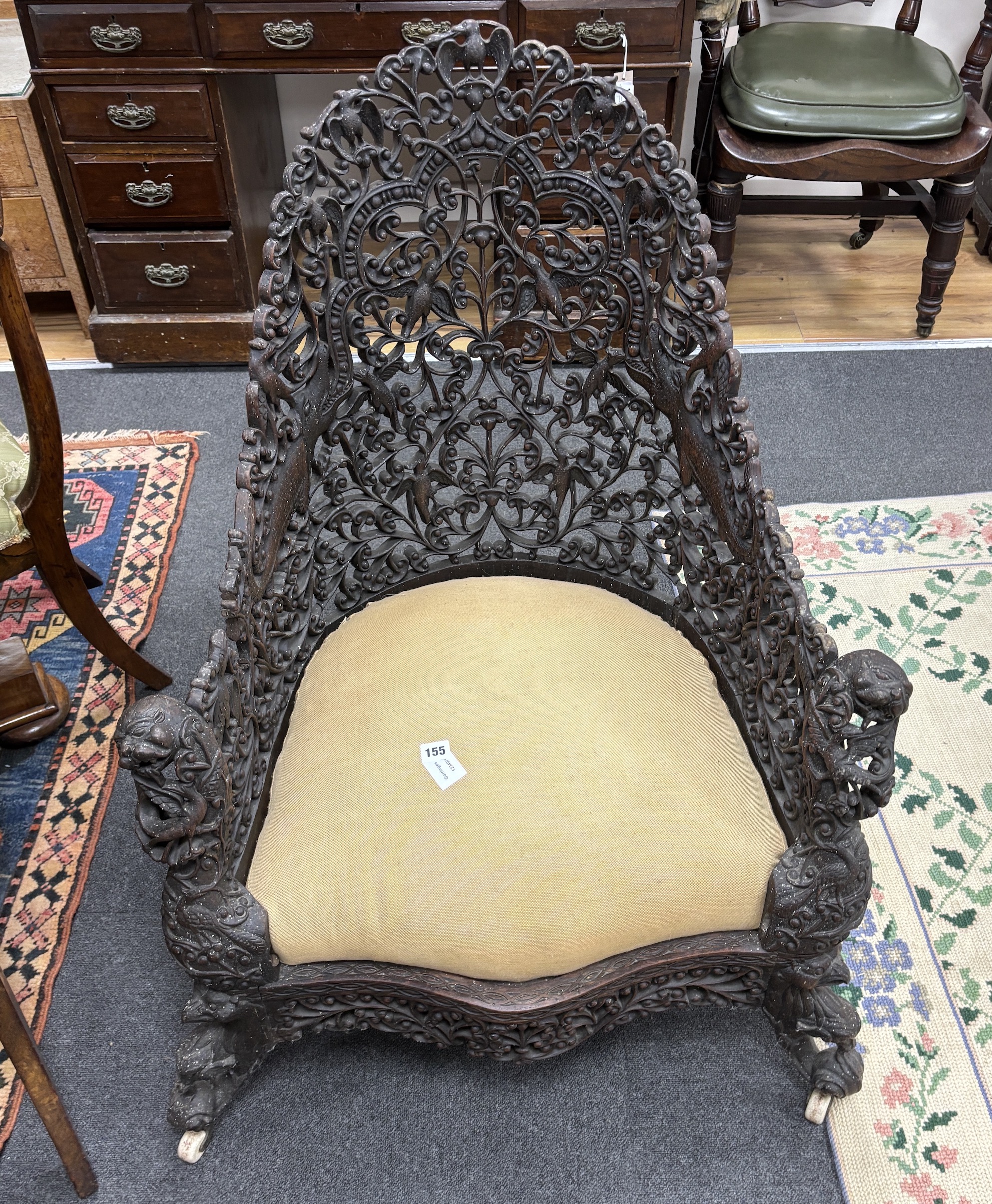 An Anglo Indian carved hardwood armchair, width 75cm, depth 58cm, height 100cm