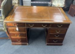 A George III style mahogany pedestal desk, width 138cm, depth 83cm, height 77cm together with a