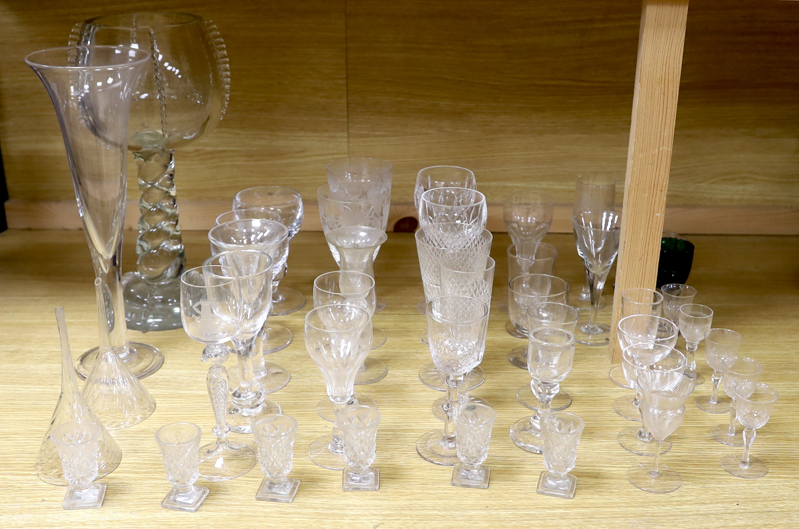 A large glass centrepiece, a teardrop trumpet shaped vase and a collection of 19th and 20th