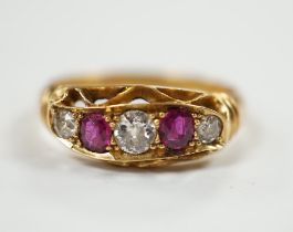 A George V 18ct gold, three stone diamond and two stone ruby set half hoop ring, size N, gross