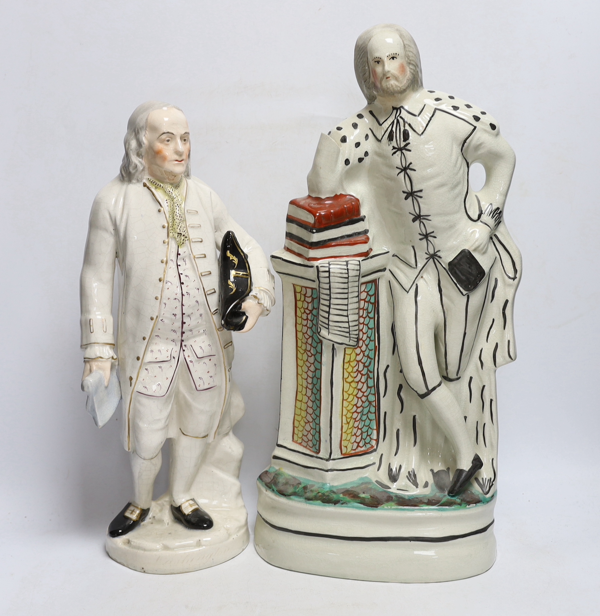 A Staffordshire pottery figure of Benjamin Franklin, modelled holding the Bill of Rights and a