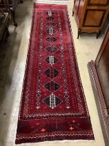 A Turkish burgundy ground runner, 286 x 75cm