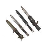 Four bayonets; two Mauser bayonets in scabbards, an American M8A1 carbine bayonet in a scabbard, and
