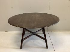 An Ercol elm drop leaf dining table, 124cm extended, width 112cm, height 71cm and six Ercol elm