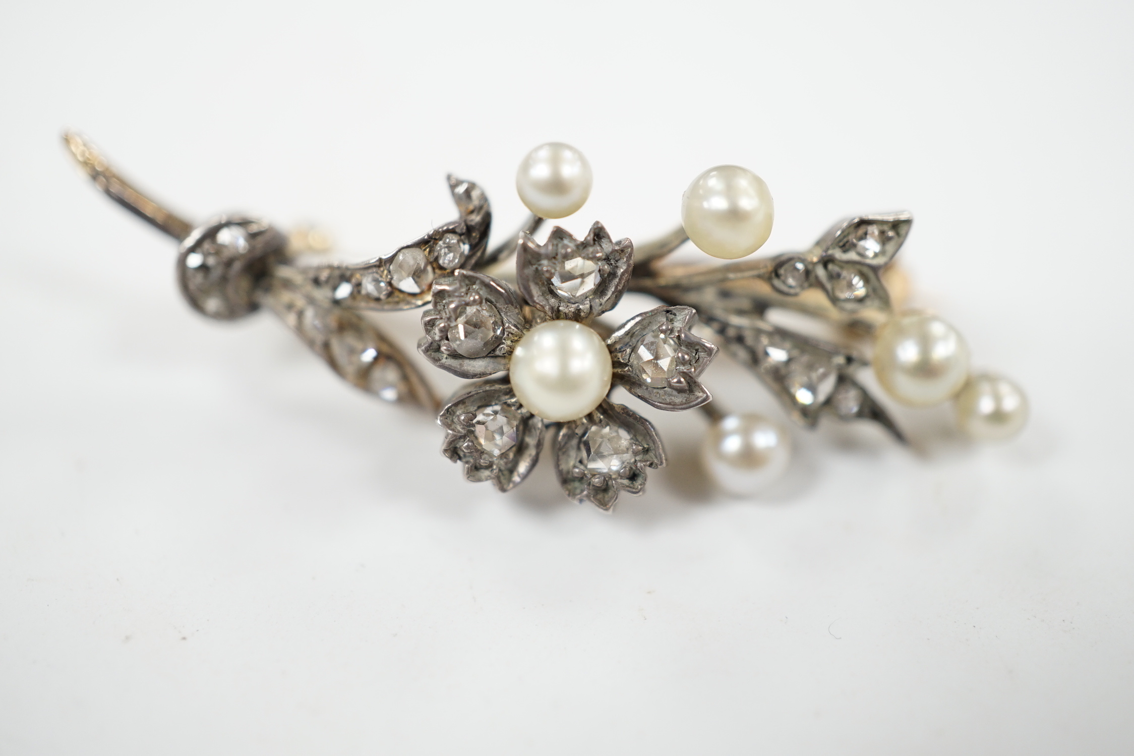 A cased Victorian yellow metal, seed pearl and rose cut diamond set foliate spray brooch, 39mm, - Image 3 of 7