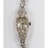 A lady's America 14k white metal and diamond cluster set manual wind cocktail watch, with diamond