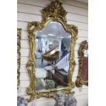 An 18th century style carved giltwood and composition wall mirror, width 72cm, height 124cm