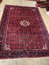 A North West Persian red ground carpet, 310cm x 215cm.