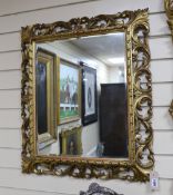 An early 20th century Florentine style rectangular carved giltwood and composition wall mirror,