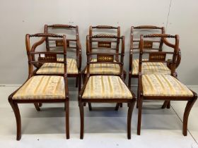 A set of six Regency style brass inlaid mahogany dining chairs, two with arms
