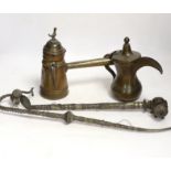 Two Indian opium pipes and two Dallah coffee pots, tallest pot 22cm