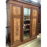 A late Victorian aesthetic movement mahogany and satin birch compactum wardrobe, width 186cm,