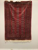A Bokhara red ground rug, 186 x 129cm