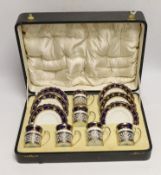 A cased George V set of six Aynsley coffee cans and saucers, the cans with pierced silver holders,