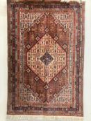 A North West Persian red ground rug, 188 x 127cm
