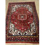 A Caucasian style red ground rug, 200 x 142cm