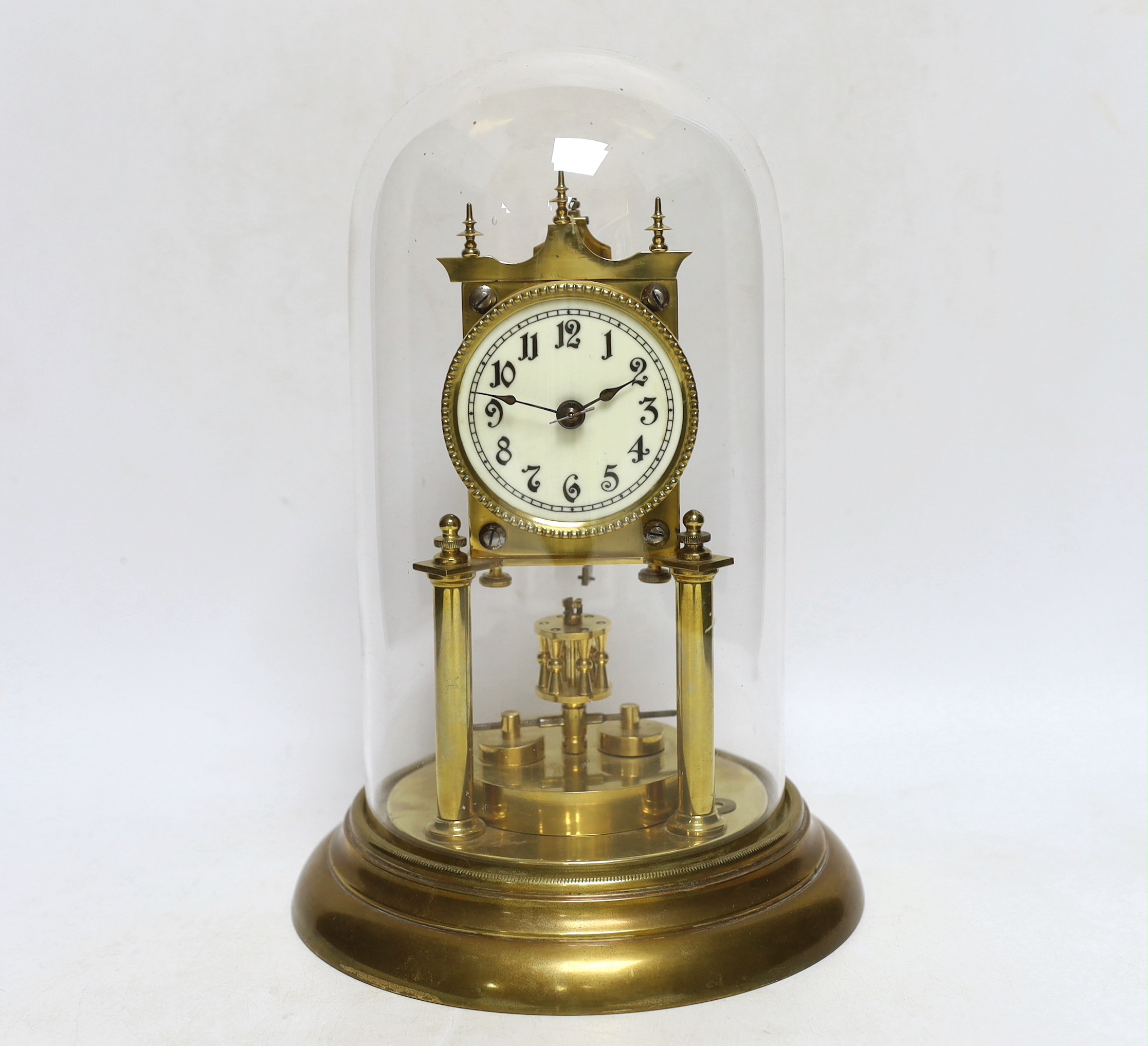 An early 20th century clock under a glass dome, 27cm high