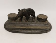 A Black Forest carved wooden inkstand, with ceramic inserts to the inkwells, 31cm wide