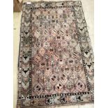 An antique Turkish faded red ground rug, 158 x 98cm