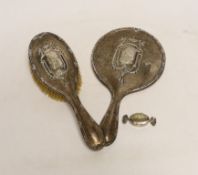 An Edwardian silver mounted hand mirror and hair brush, Henry Matthews, Birmingham, 1908 and a
