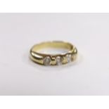 A yellow metal and three stone simulated diamond set ring, size K, gross weight, 2.7 grams.
