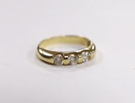 A yellow metal and three stone simulated diamond set ring, size K, gross weight, 2.7 grams.