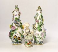 A pair of Minton flower encrusted bottle vases and covers, c.1835, and a Minton seated figure of a