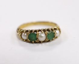 An 18ct, two stone emerald and three stone split pearl set half hoop ring, size P, gross weight 4.