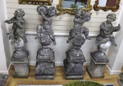 A set of four reconstituted stone garden ornaments formed as musical putti, on two differing pairs