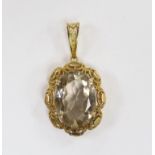 A 9ct gold and single stone oval cut pale smoky quartz set pendant, 50mm, gross weight 12.7 grams.
