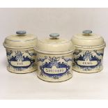 Three French cream and blue glazed storage jars and covers, Caffé, Thé and Zucchero, 18cm high