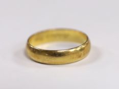 A modern Cartier 750 yellow metal wedding band, signed and numbered 62 JA 0005, with engraved