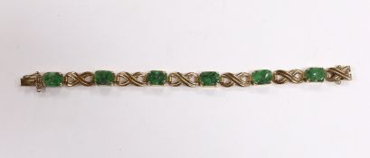 A 9ct gold and six stone carved jade panel set bracelet, 17cm, gross weight 15.2 grams.