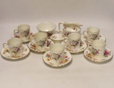 A Royal Crown Derby Posies coffee set comprising of seven cups and saucers, a sugar bowl and milk