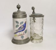 Two German steins including a faience example, together with a glass inkwell, largest 24cm high