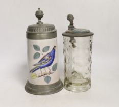 Two German steins including a faience example, together with a glass inkwell, largest 24cm high