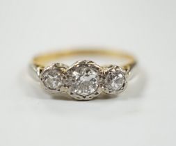 An 18ct, plat and illusion set three stone diamond ring, size J/K, gross weight 2.6 grams.